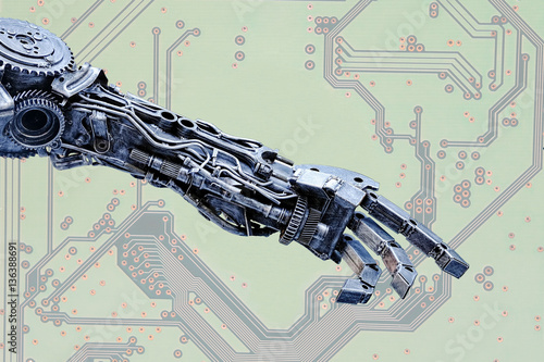 Double Exposure Left arm of a robot made from car parts and spares on Circuit board background