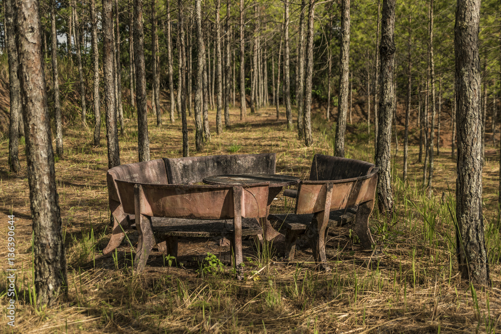Old table and chairs in forest near temple Old table and chairs in forest near temple