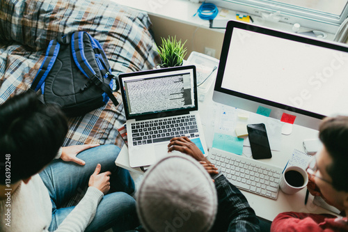Overhead view of friends working on a coding project