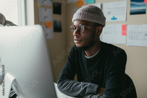 African american man reading his computer screen