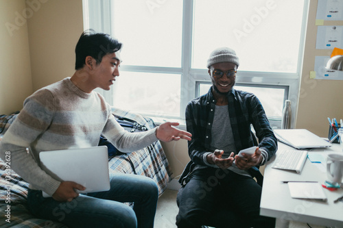 Two friends talking in a dorm room photo