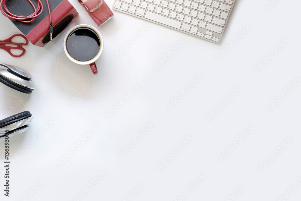 White office desk table with a red gadget . Top view with copy space, flat lay or hero header concept. White office desk table with a red gadget . Top view with copy space, flat lay or hero header concept.