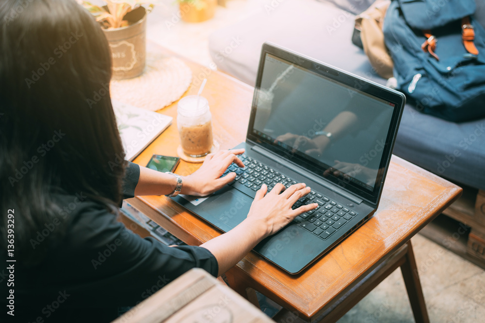 woman using laptop computer. Female working on laptop in an outdoor cafe. woman using laptop computer. Female working on laptop in an outdoor cafe.