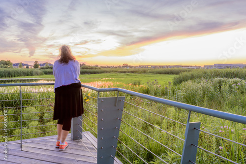 Woman views the prairie landscape  photo