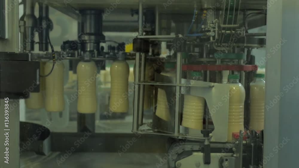 Milk production on line at the factory, a lot of bottles Milk production on line at the factory, a lot of bottles