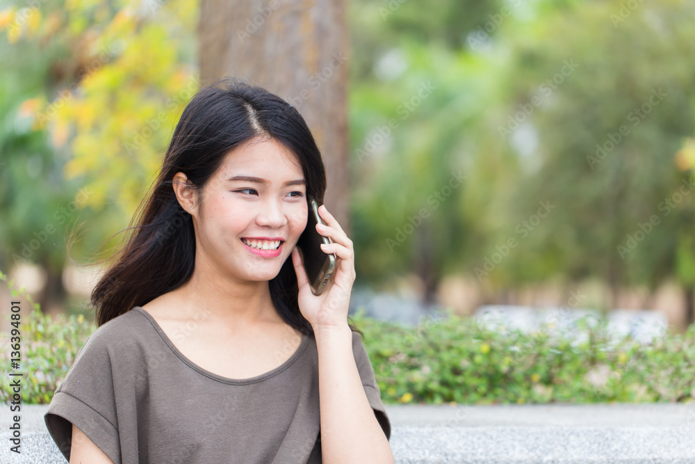 Asian women enjoy on phone call, teen calling using smartphone. Asian women enjoy on phone call, teen calling using smartphone.