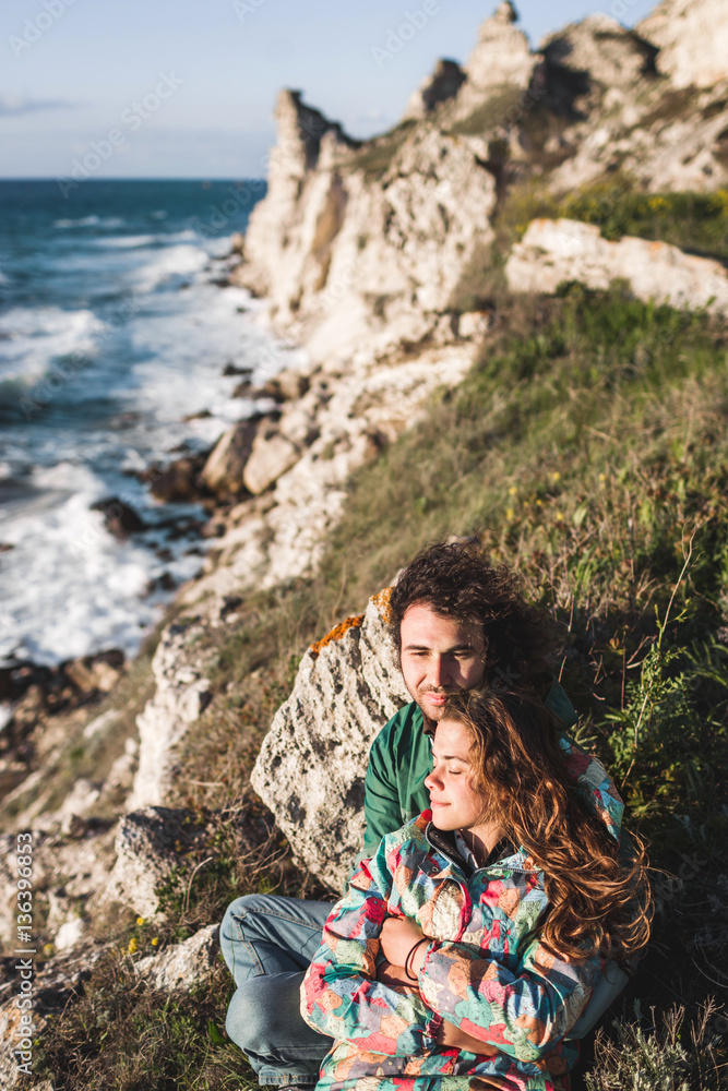 Guy and girl relaxing on the seaside with amazing view together Guy and girl relaxing on the seaside with amazing view together