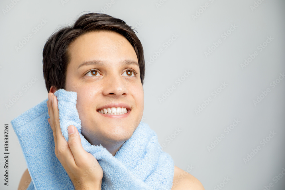 young man toweling his face, men's skin care concept Stock Photo