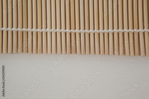 Straw sushi mat against white background