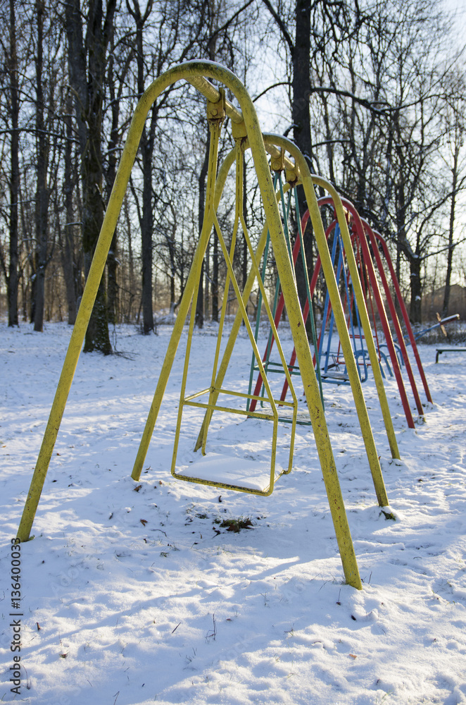 Row of the teeter in the desert winter park (city of Porkhov, Russia) Row of the teeter in the desert winter park (city of Porkhov, Russia)