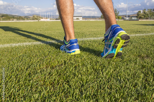 athlete runner feet shoes green grass
