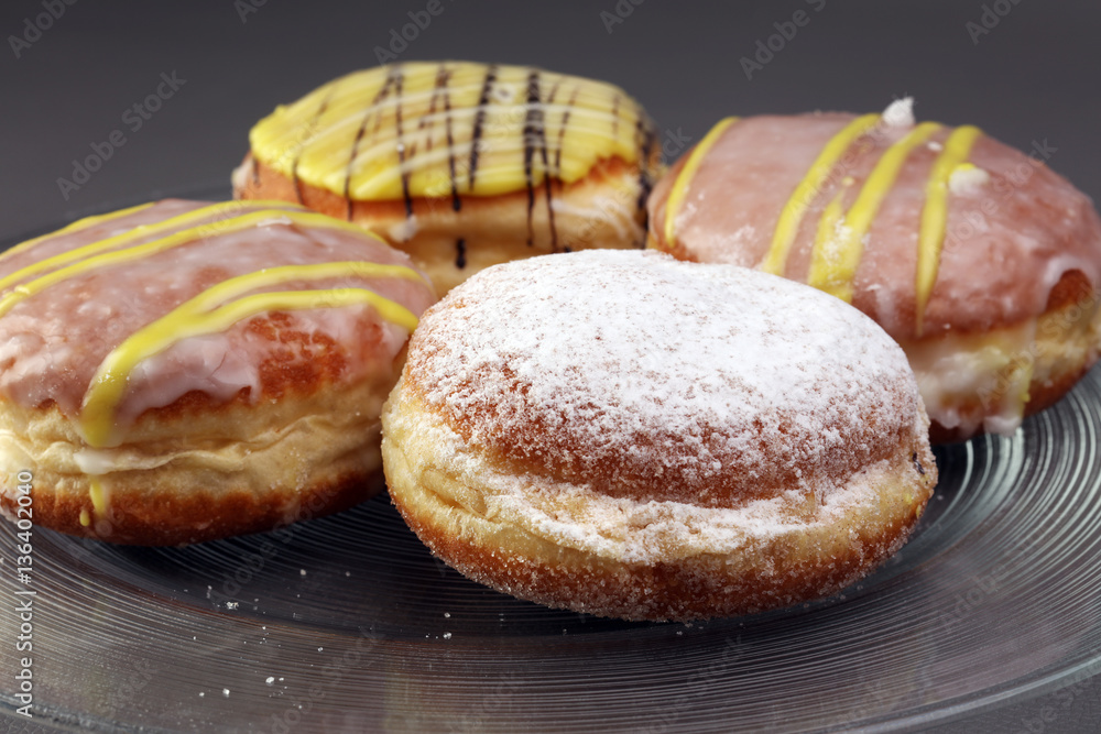 German donuts - berliner with jam and icing sugar in a tray on a German donuts - berliner with jam and icing sugar in a tray on a