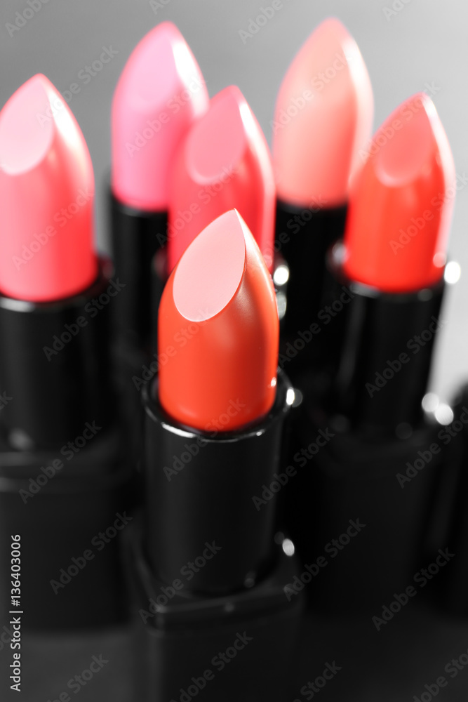 Lipsticks in different shades of red and pink, closeup Lipsticks in different shades of red and pink, closeup