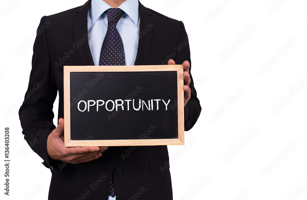 Businessman holding mini blackboard with OPPORTUNITY message Businessman holding mini blackboard with OPPORTUNITY message