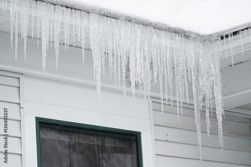 Fototapeta premium icicle hanging on the house roof