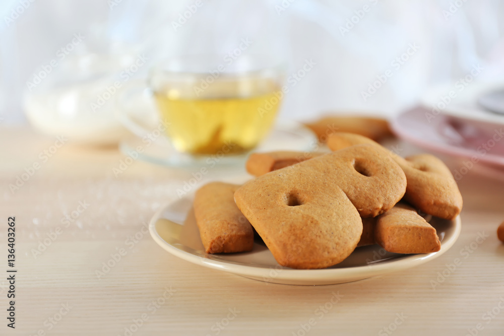 Cookie alphabet and tea on table Cookie alphabet and tea on table