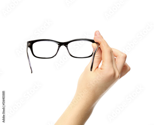 Woman holding spectacles on white background