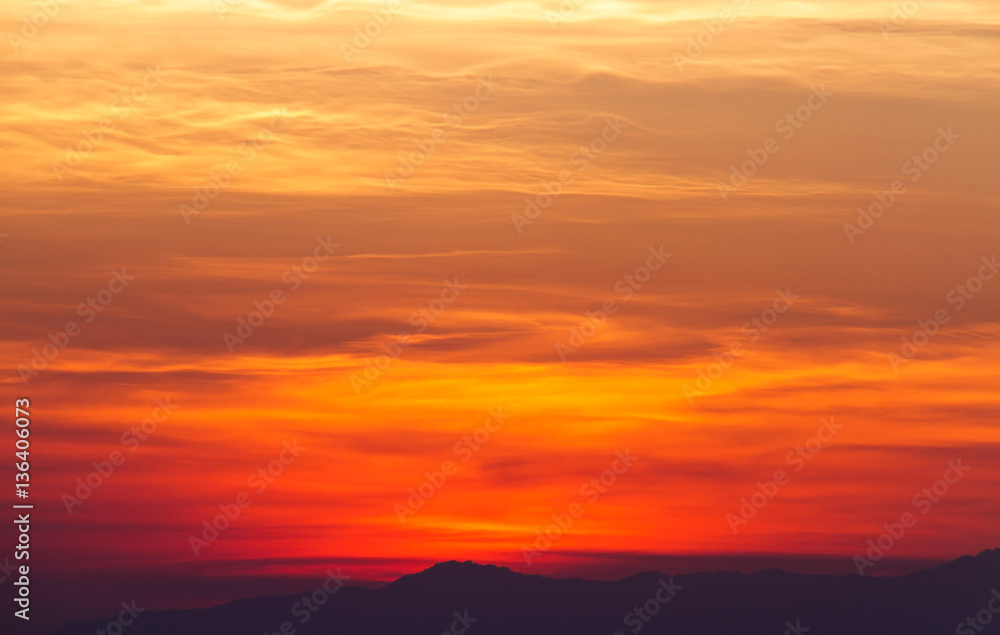 Dramatic sunset setting above mountain