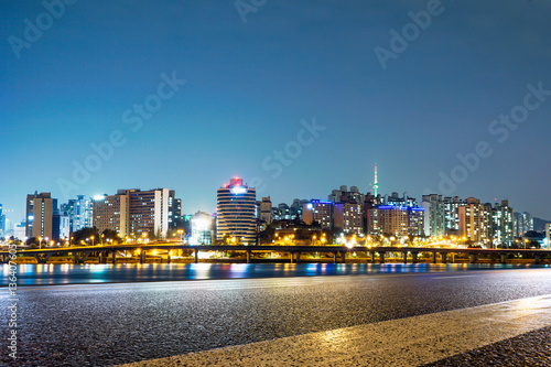 cityscape and skyline of seoul at night from empty road