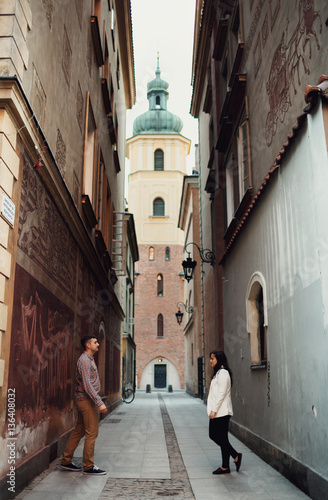 Young couple in the narrow alley in the city