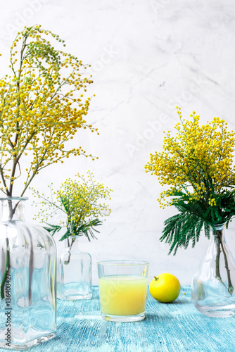 mimosa in glass vase on table close up