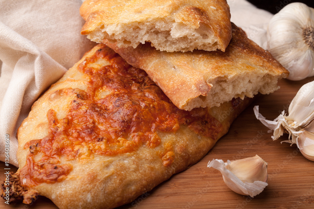 Fresh homemade bread, ciabatta with cheese and garlic Fresh homemade bread, ciabatta with cheese and garlic