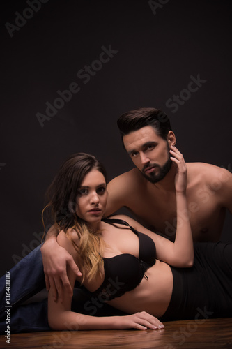 young couple woman man lying laying, sexy bra shirtless