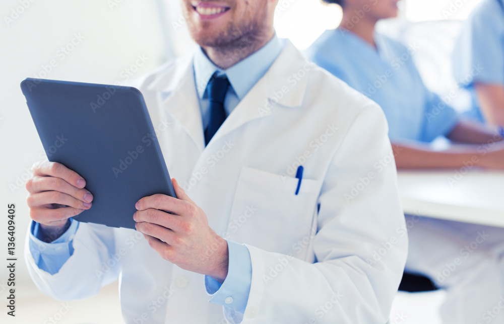 close up of happy doctor with tablet pc at clinic close up of happy doctor with tablet pc at clinic