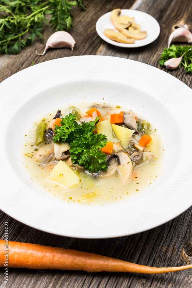 Vegetable Soup with Carrot, Mushrooms, Parsley Leaves, Garlic and Potatoes