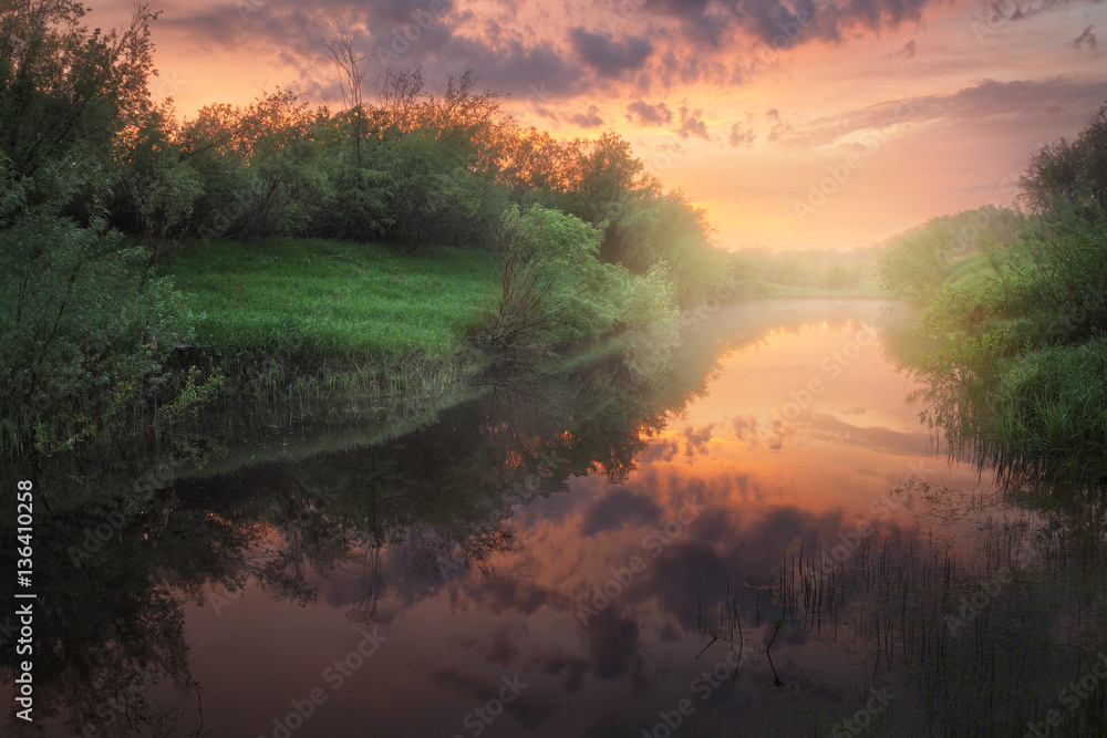 sunset reflected in the pond, a slight mist in the background sunset reflected in the pond, a slight mist in the background