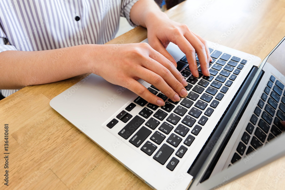 Woman office worker is typing keyboard of laptop, business or le Woman office worker is typing keyboard of laptop, business or le