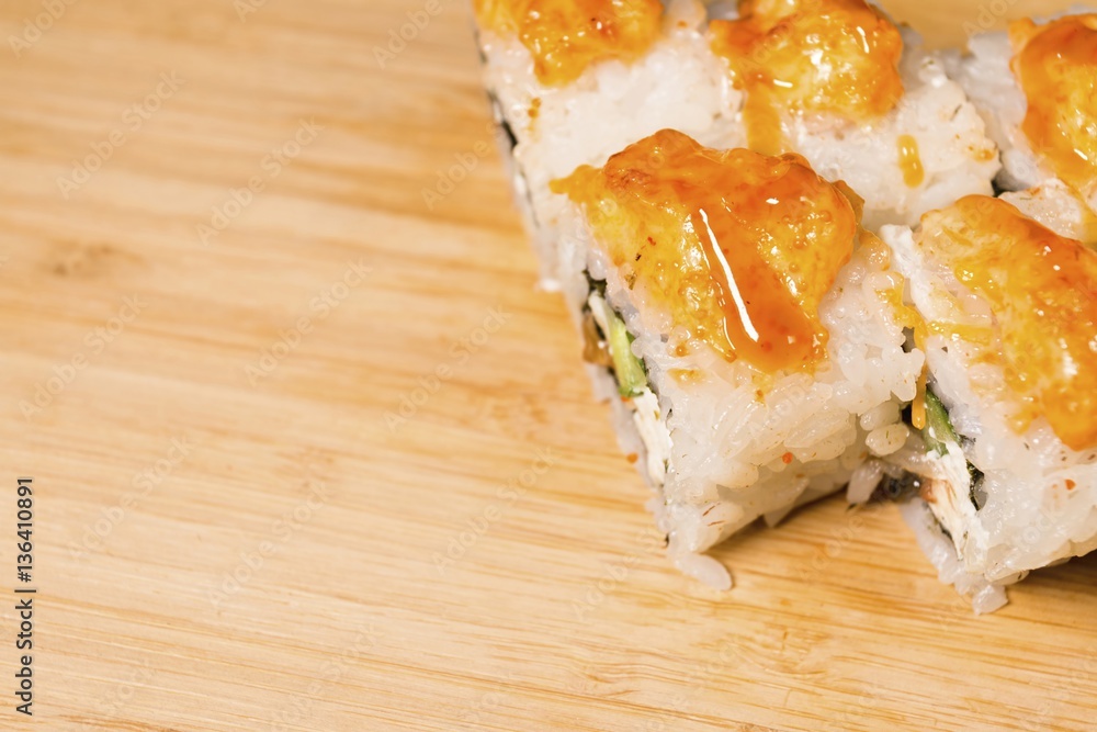 Fresh Japanese sushi and rolls on wooden table. Macro shot. Fresh Japanese sushi and rolls on wooden table. Macro shot.