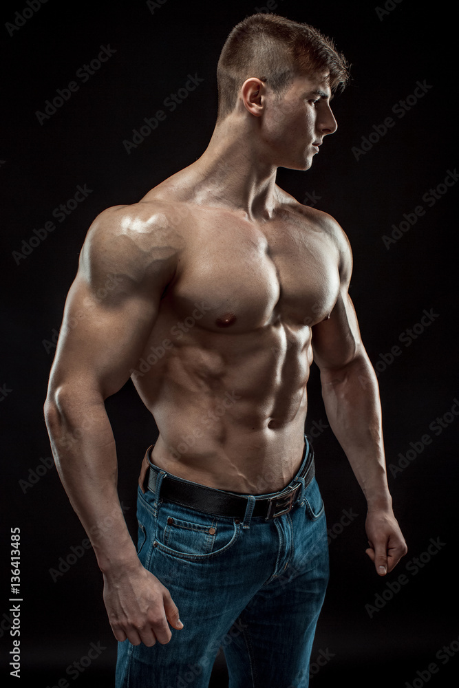 Fototapeta premium Young bodybuilder man on black background