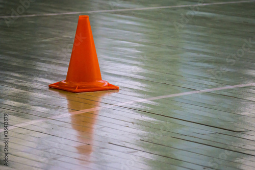 Interior of a gym at school, red cones on the floor