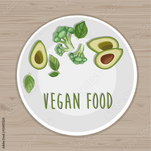 Vegan food. Plate with avocado, broccoli and basil leaves. Top view. Wood background.  Hand drawn illustration. Title page for your receipt book.