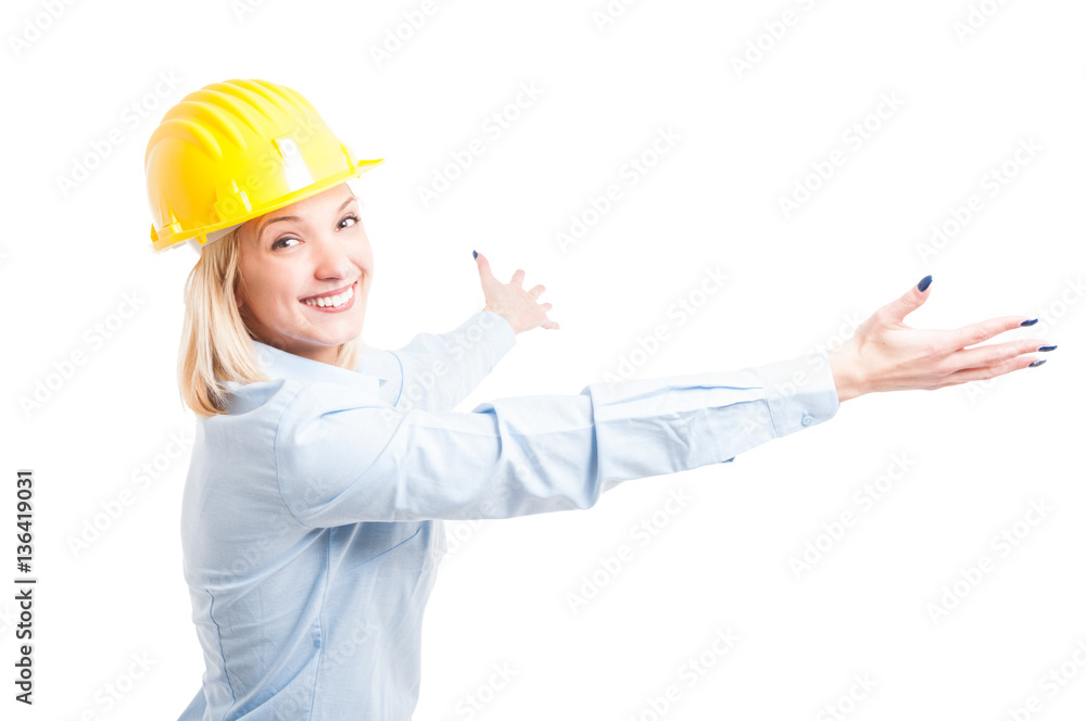 Lady engineer wearing helmet posing with arms open Lady engineer wearing helmet posing with arms open