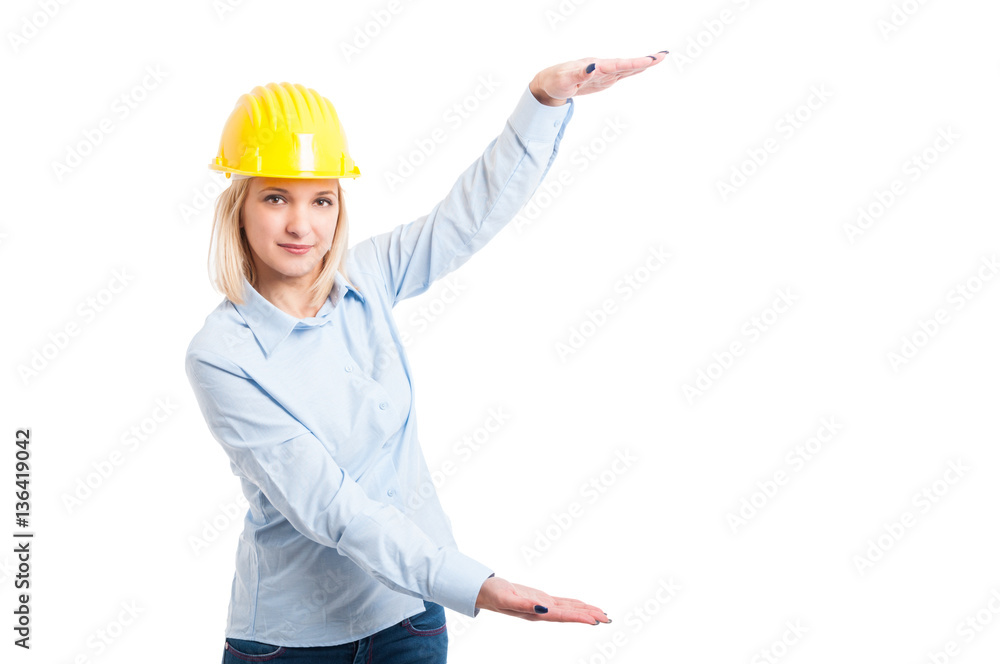 Lady engineer wearing helmet showing big copy space Lady engineer wearing helmet showing big copy space