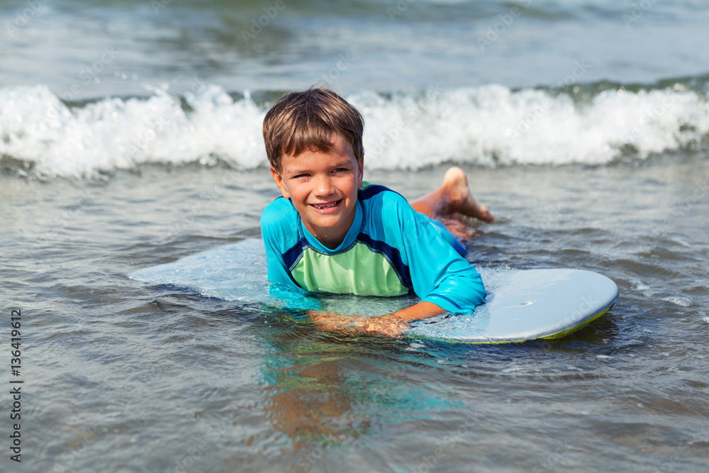 Portrait of happy cute boy swimming in sea Stock Photo | Adobe Stock