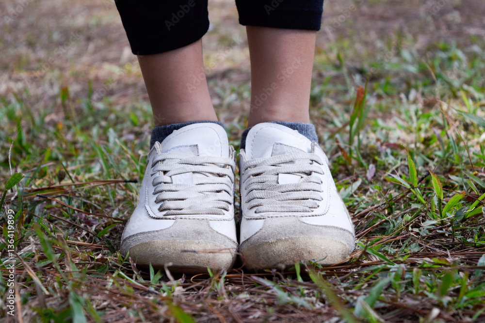Girl Foot wear White Sport Shoe on the grass field