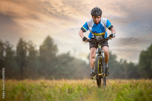 Mountain Bike cyclist riding single track outdoor during sunset
