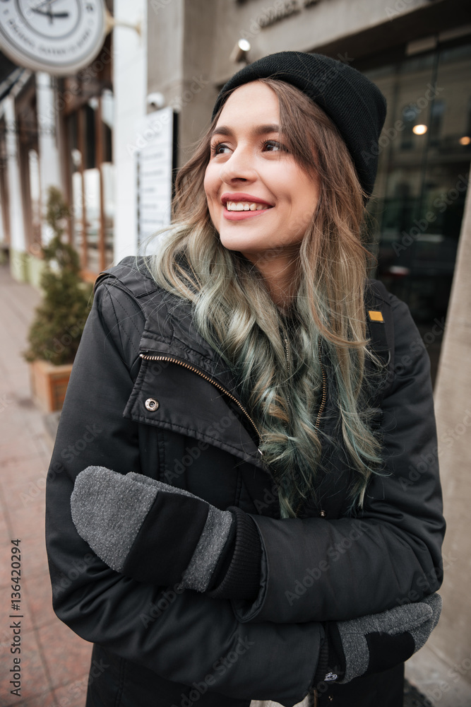 Happy lady wearing hat walking on the street Happy lady wearing hat walking on the street