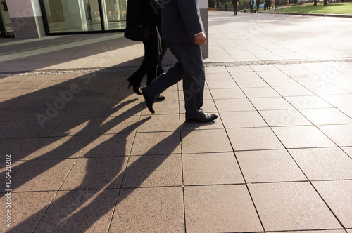 Anonymous crop of business people walking