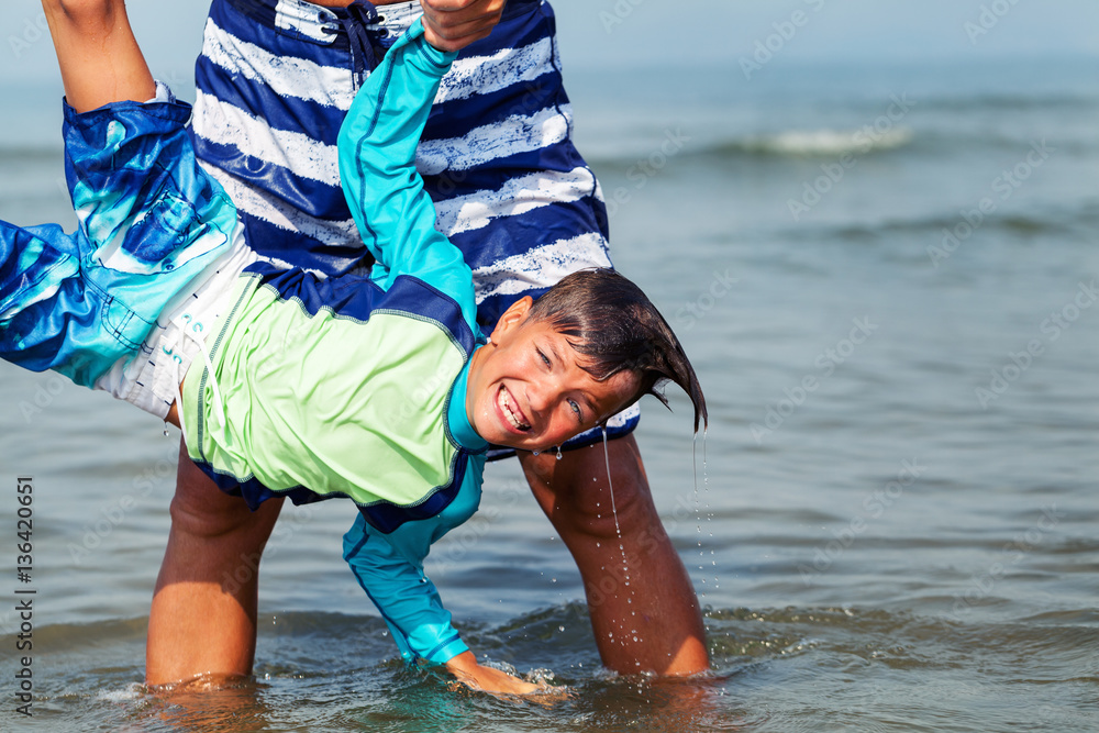 Portrait of happy cute boys swimming in sea Stock Photo | Adobe Stock