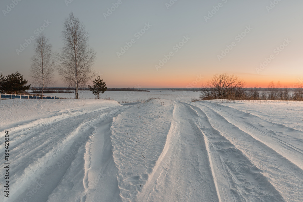 snowy road in winter village at dawn. snowy road in winter village at dawn.