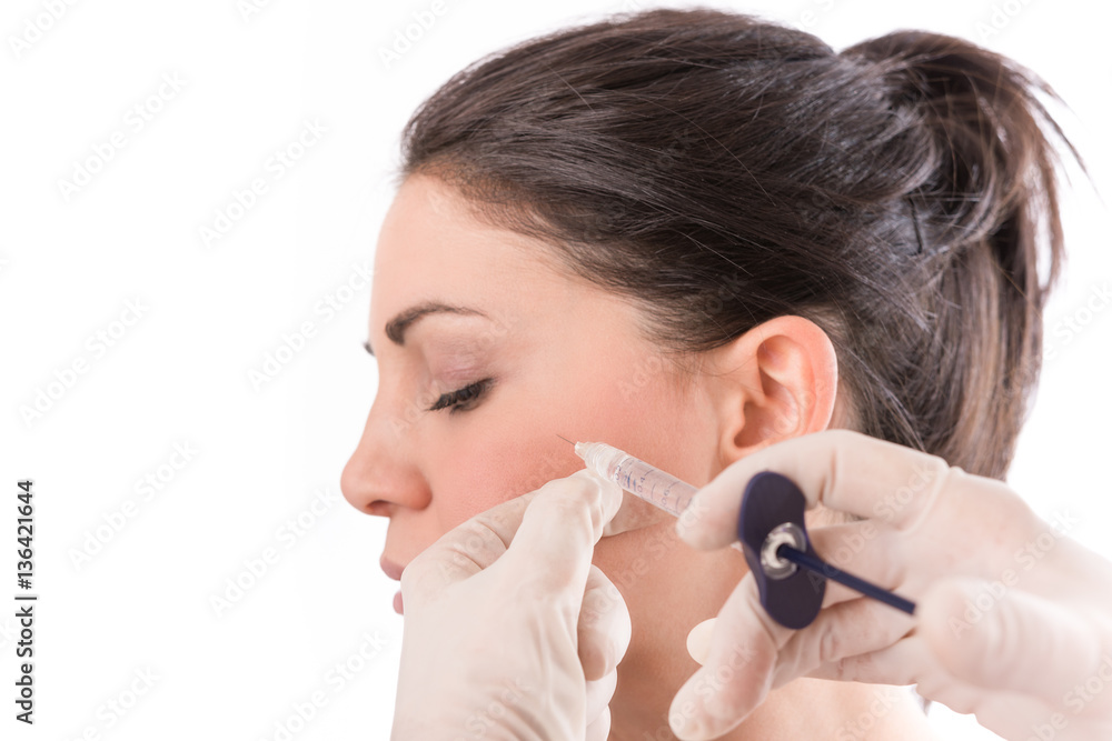 Closeup of beautiful woman receiving hyaluronic acid treatment. Isolated over white background. Closeup of beautiful woman receiving hyaluronic acid treatment. Isolated over white background.
