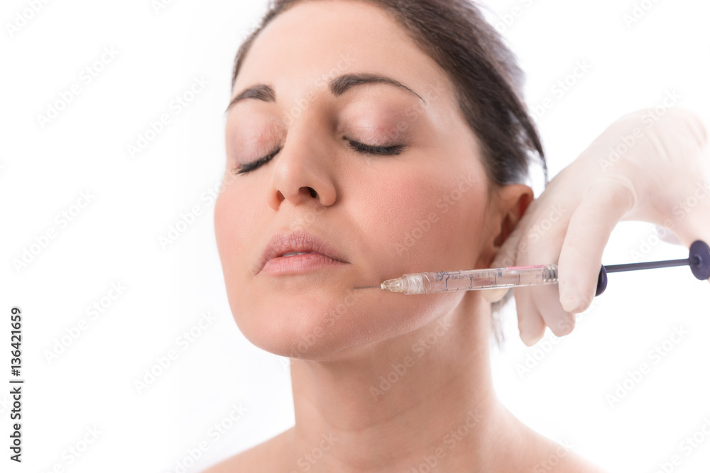 Closeup of beautiful woman receiving hyaluronic acid treatment. Isolated over white background. Closeup of beautiful woman receiving hyaluronic acid treatment. Isolated over white background.