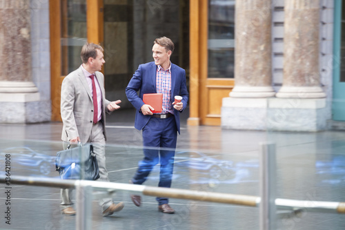 Businessmen walking outside the office
