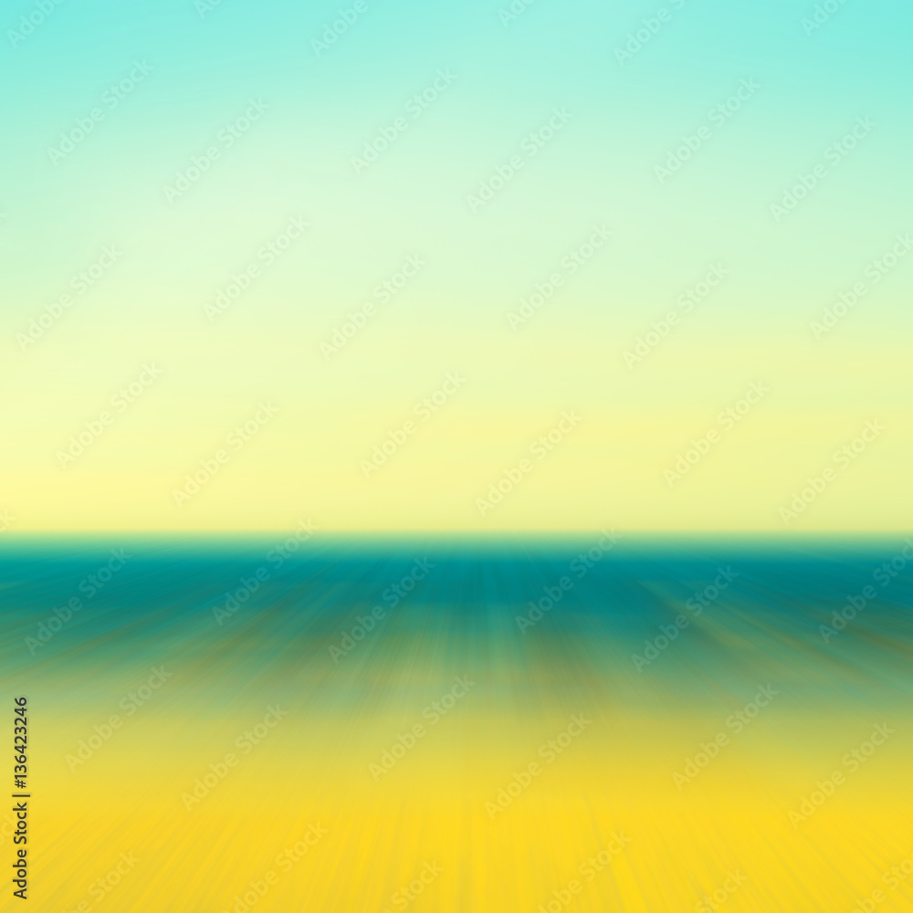 Blurred travel background with sky, water and sand