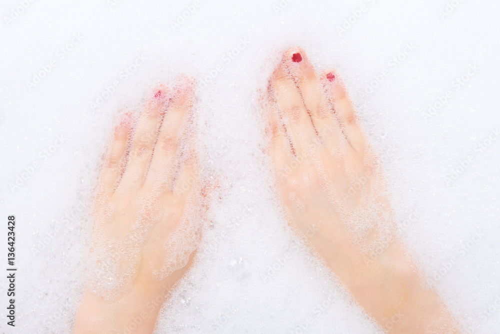 Childs hands in shampoo foam in bath. Healthcare and hygiene concept. Childs hands in shampoo foam in bath. Healthcare and hygiene concept.