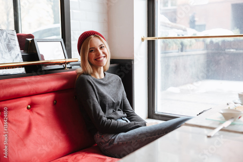 Smiling hipster sitting in cafe Free Download Smiling hipster sitting in cafe - GFXLoad